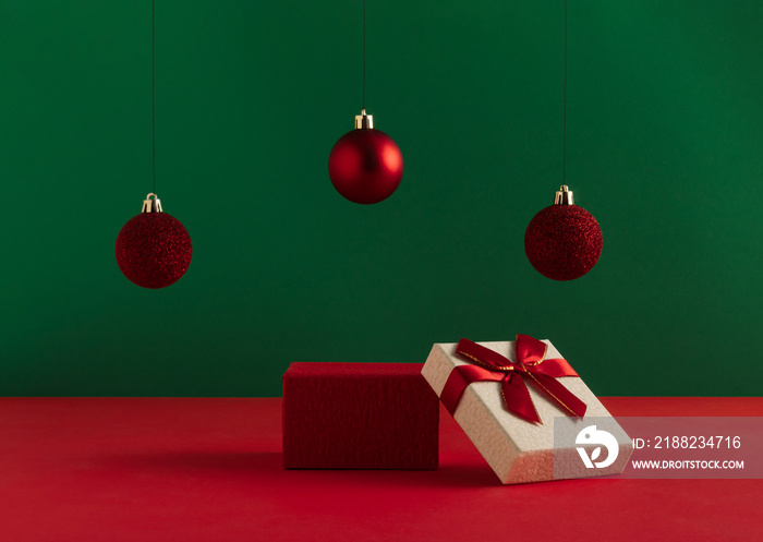 Creative Christmas concept made of podium and red baubles on bold green background. Minimal New Year advertisement concept. Mock up showcase for product, promotion, sale or presentation.