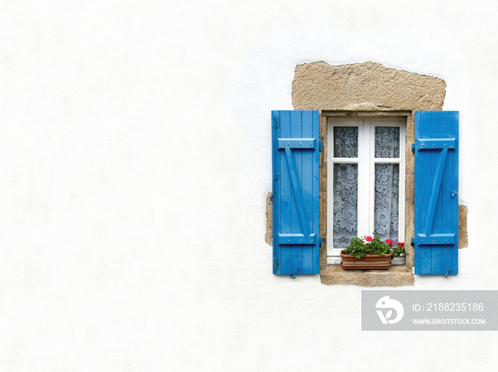 Blue shuttered window on white wall with space for text. Traditional architecture of Brittany, France.