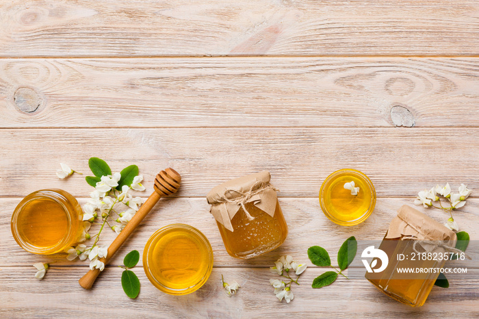 honey jar with acacia flowers and leaves. fresh honey top view flat lay