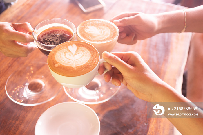 Business coffee break after success discussion cheers the cup of coffee.Friendship meeting in weekend at coffee shop.People hand holding coffee cup and cheers for agreement after negotiation.