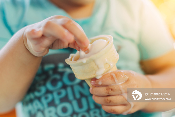 Cute happy baby girl are eating ice cream in summer. Picture for concept of sweet ,fat ,obesity and diabetes in children.Soft focus.