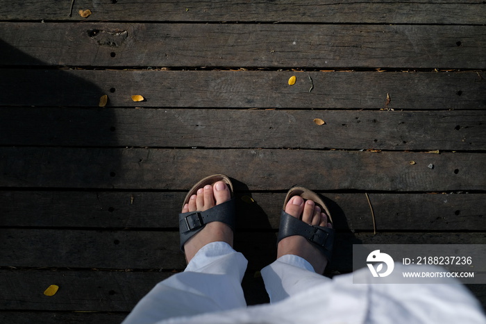 person stand on wooden floor