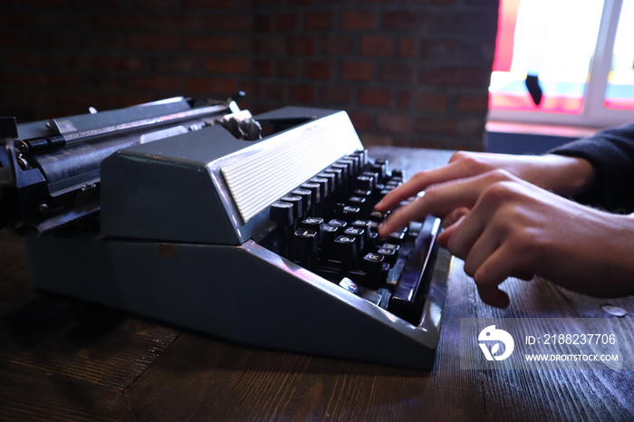 Hands typing on vintage old typewriter