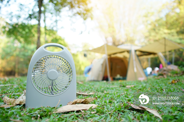 Mini fan 5V USB or 12VDC for cool picnic or camping tent on summer season and hot weather on green grass meadow in national park jungle for family vacation on holiday relax travel with warm sunlight