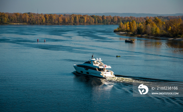 Beautiful new yacht and picturesque autumn river landscape