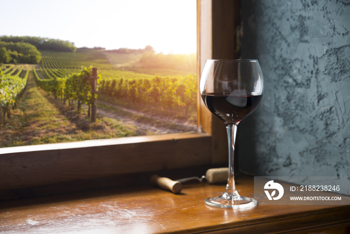 Red wine with barrel on vineyard in green Tuscany, Italy