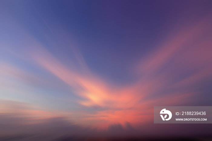 Blur sunset sky background. Blue sky with pink light background at sunrise. Sky cloud backgrounds. Sky clouds with bird or angel wings shaped. Backdrop for inspirational background.