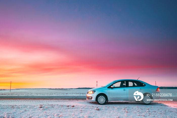 Volkswagen Polo Car Sedan Parking On A Roadside Of Country Road On A Background Of Dramatic Sunset Sky At Winter Season