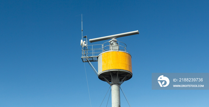 air surveillance, observation and security concept - coastal radar of vessel traffic control system over blue sky