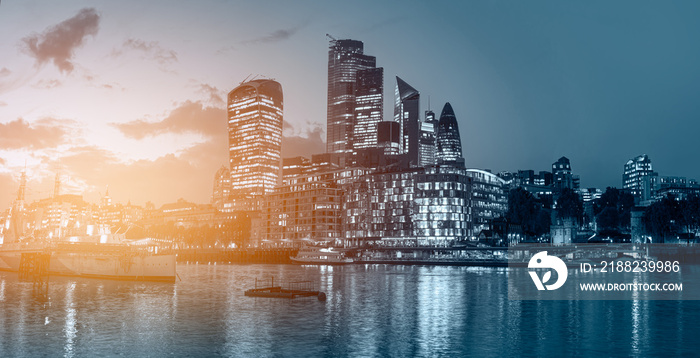 Panorama of the modern skyline on Thames river at twilight blue hour - London, United Kingdom -                Night view of the downtown City of London