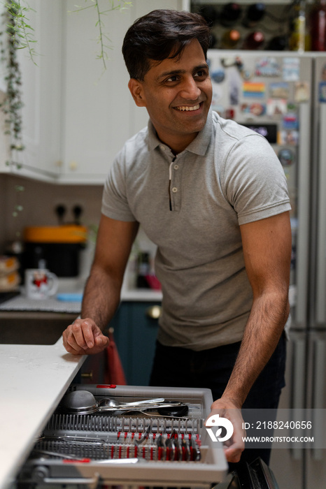 Man putting dishes into dishwasher