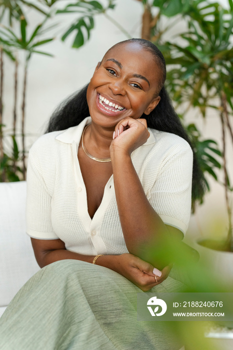 Happy woman sitting in office lounge