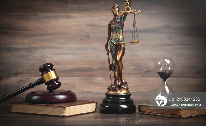 Statue of Lady Justice, hourglass, book and gavel.