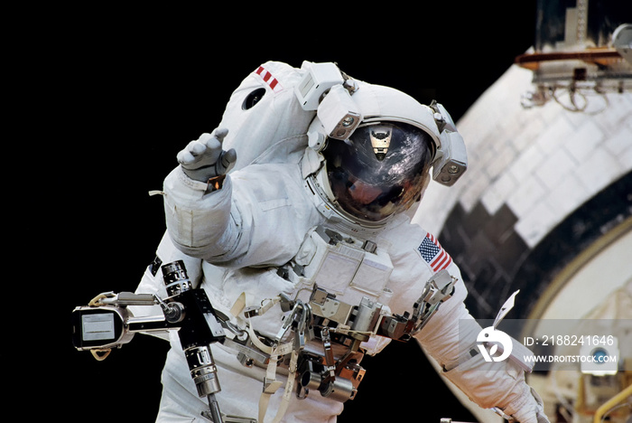 Close up of an astronaut waving hi to the camera.Elements of this image furnished by NASA.