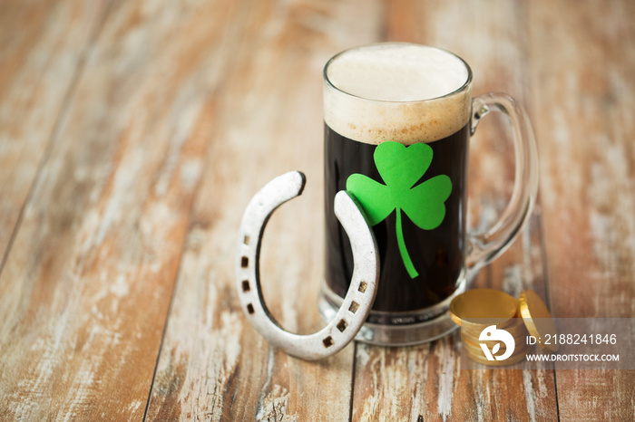 shamrock on glass of beer, horseshoe and coins