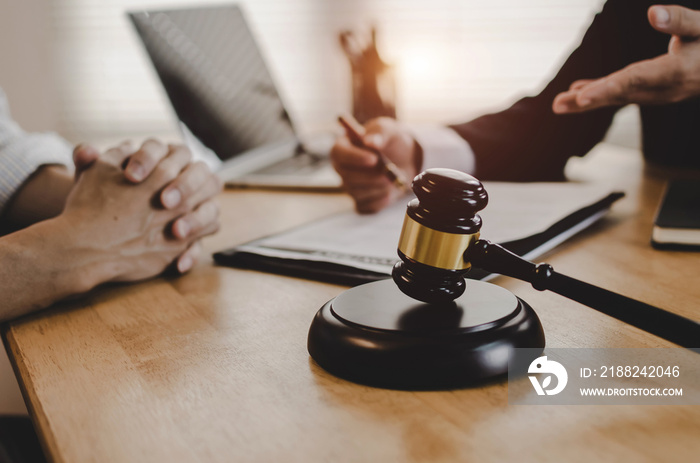 legal consultants, notary or justice lawyer discussing contract document with customer and wooden judge gavel on desk in courtroom office, business, justice law, insurance and legal service concept