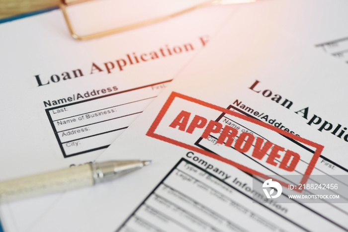 Loan approval, Loan application form with Rubber stamping that says Loan Approved, Financial loan money contract agreement company credit or person.