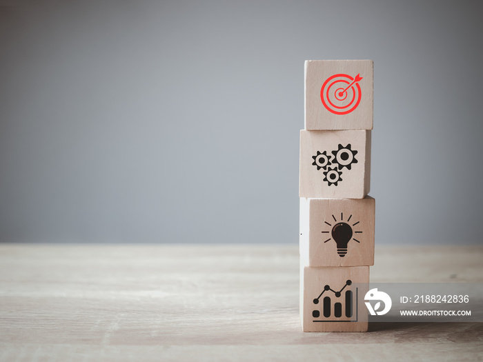 Business goal target achievement concept of business strategy and action plan on wooden cube block stacking with icon, copy space background