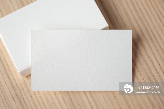 White business card on wood table background