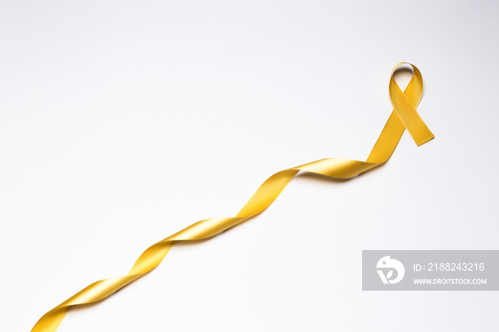 childhood ribbon, gold ribbon as symbol of childhood cancer awareness isolated on white background