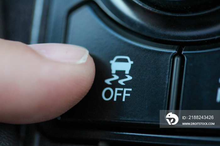 Finger on traction control button