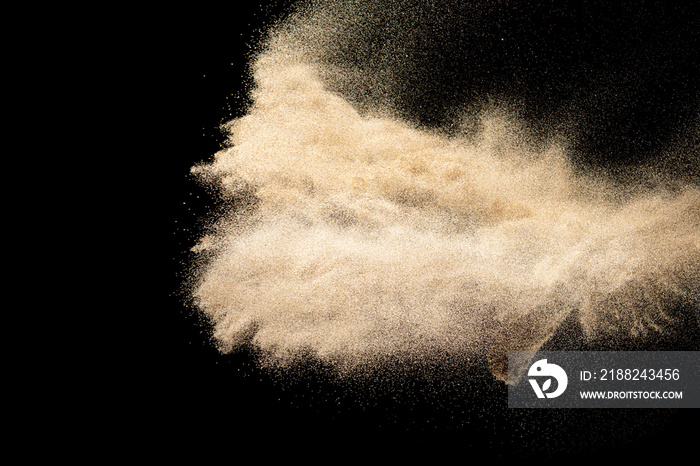 Brown colored sand splash.Dry river sand explosion isolated on black background. Abstract sand cloud.