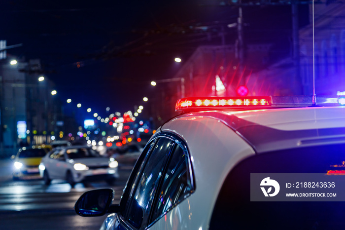 police car lights in night city with selective focus and bokeh