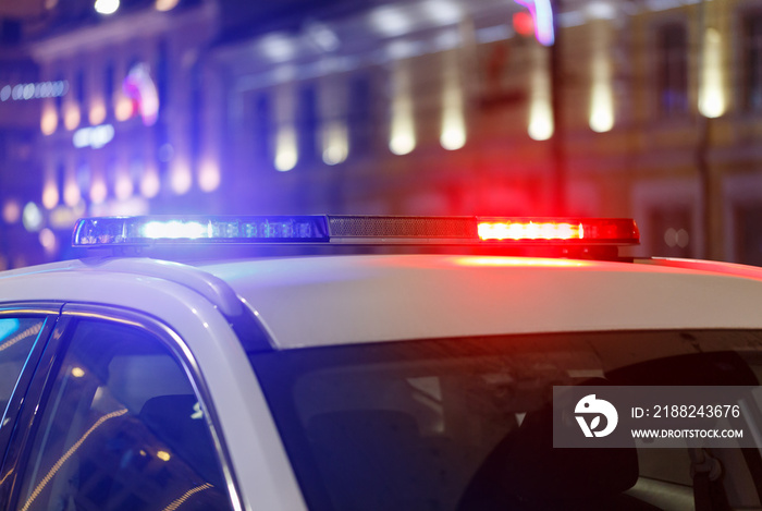 night police car lights in city with selective focus and bokeh blur