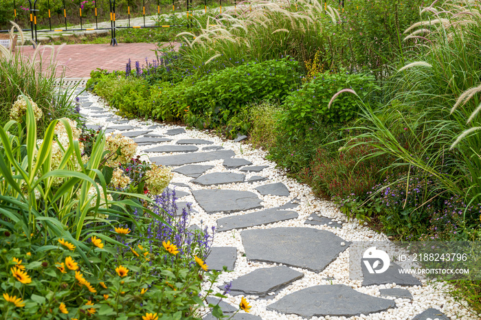 Walking path and zen-like white pagoda gravel landscape in Japanese garden