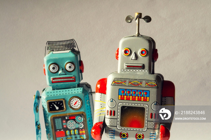 Two vintage tin toy robots, robotic delivery, artificial intelligence concept