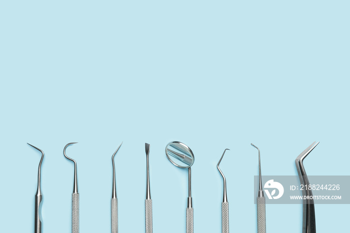 Dentist’s tools on color background