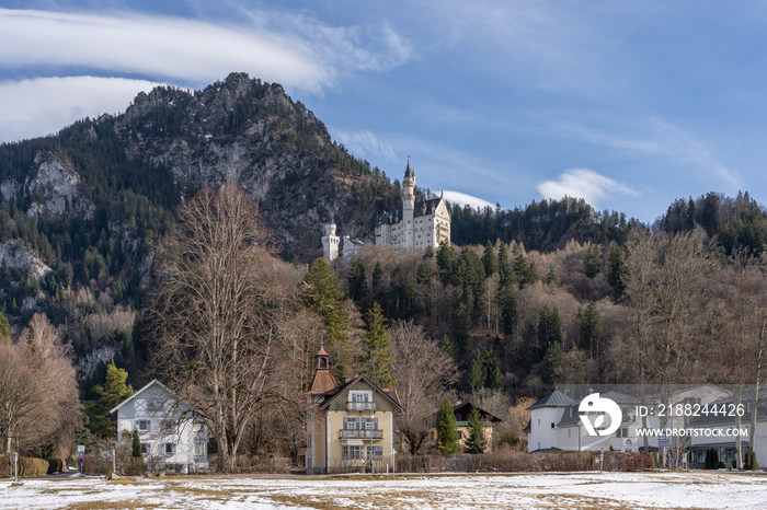 Schloss Neuschwanstein castle in Hohenschwangau, Fussen Bavaria, Germany with typical house in the foreground