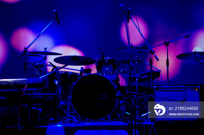 Musical drum kit and stage microphones.