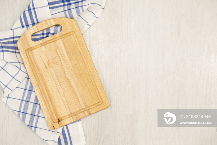 Cutting board over towel on wooden kitchen table. Kitchen blue color kitchen cloth. Food decoration.Textile on a gray background. mockup, Top view. flat lay. copy space for text