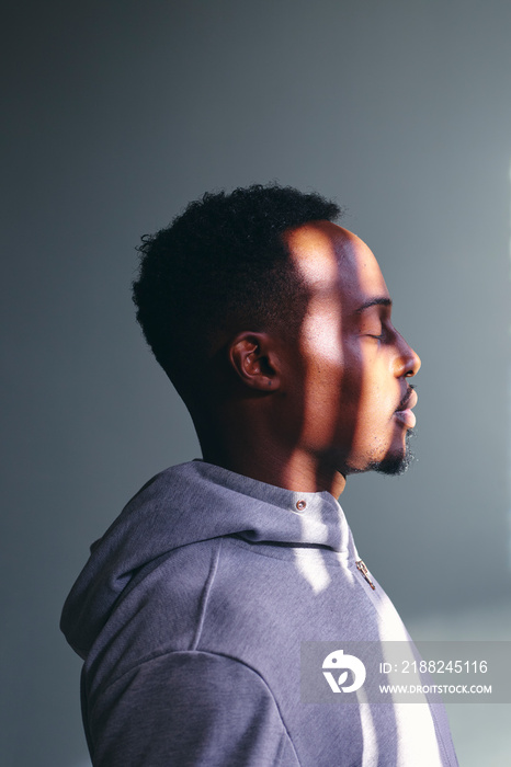 Profile of mid adult man in sweatshirt