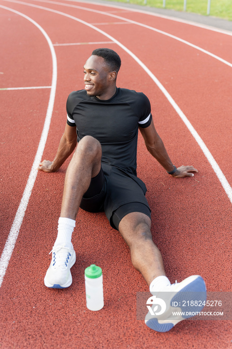 Athlete resting at sports track after training