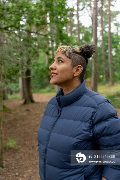 Smiling mature woman hiking in forest