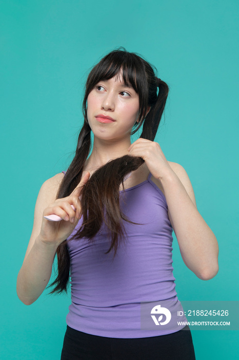 Studio shot of girl brushing hair