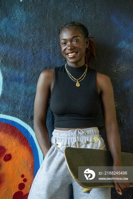 Portrait of young female skateboarder