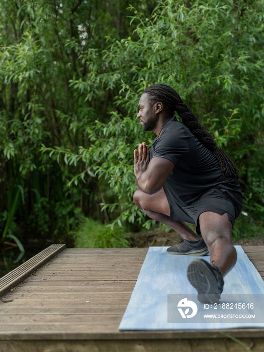 Man practicing yoga in park