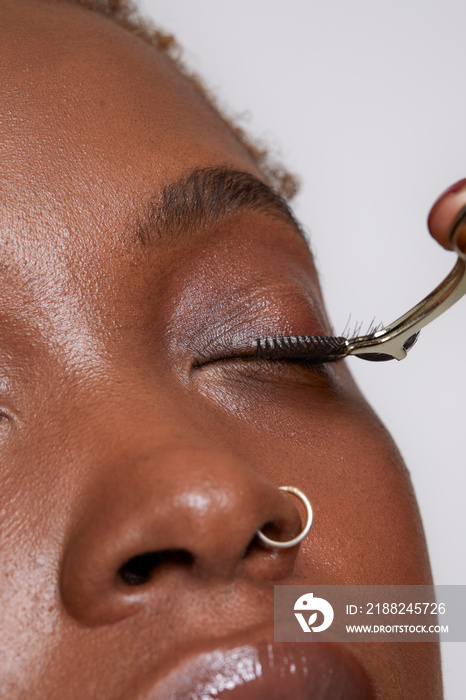 Close-up of woman removing false eyelashes