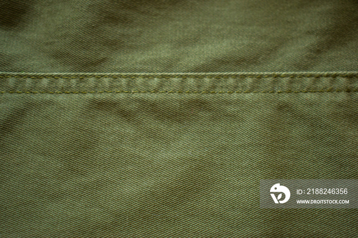 Background of green grunge military fabric, cloth with textures.