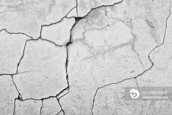 black and white shot of cracked concrete wall texture background