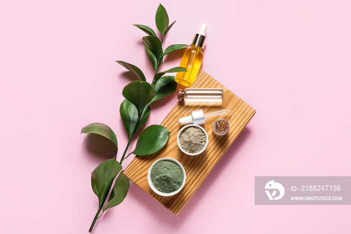 Tray with henna powder and essential oil on color background