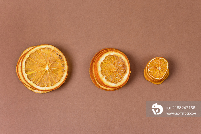 Dried Citrus Clices Chips on Brown Background Dehydrated Crispy Fruit Slices Sun Dried Crunchy Citrus Healthy Meal Snack Top view