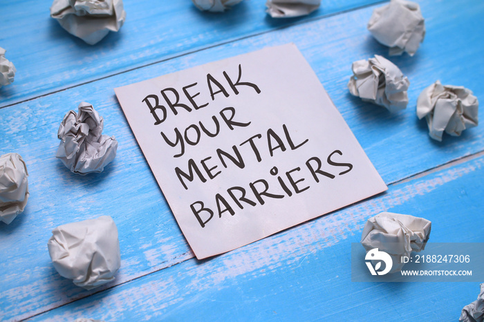 Break your mental barriers, text words typography written on book against wooden background, life and business motivational inspirational