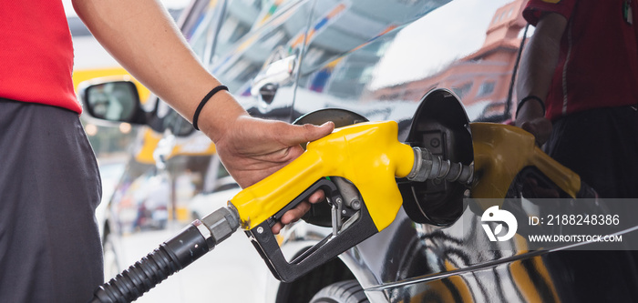 Staff in uniform hand holding gun refueling gasoline vehicle car