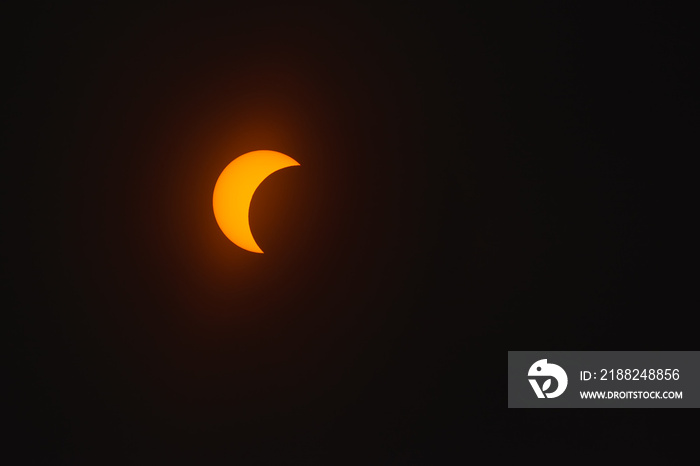 Solar eclipse in dark red glowing sky, amazing scientific background