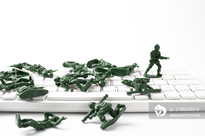 green soldier toy on white keyboard in leadership business concept