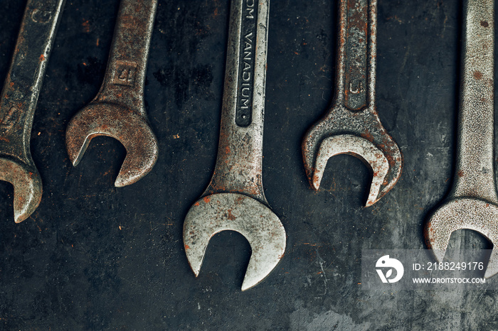 Spanners on steel surface. Old rusty wrenches for maintenance. Mechanic hardware tools to fix. Technical tools background